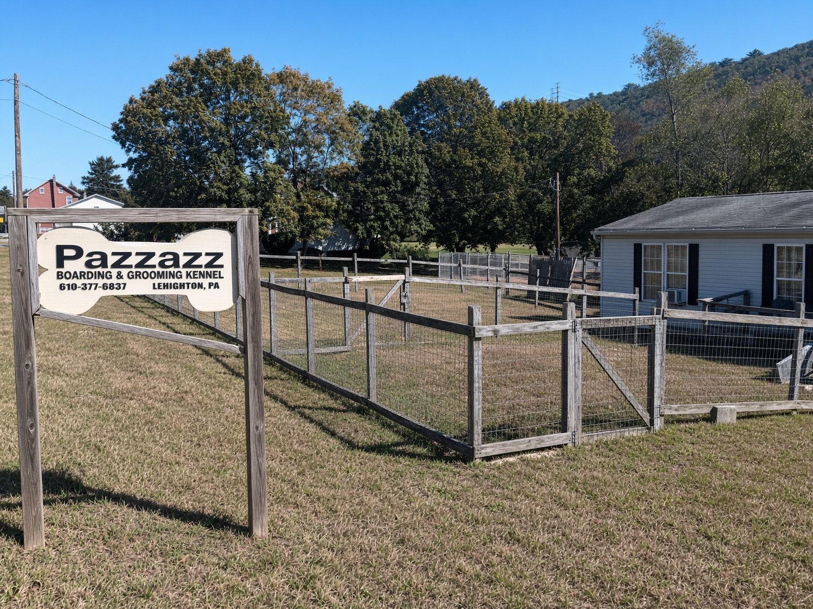 Wire fence enclosure with wooden posts and gate